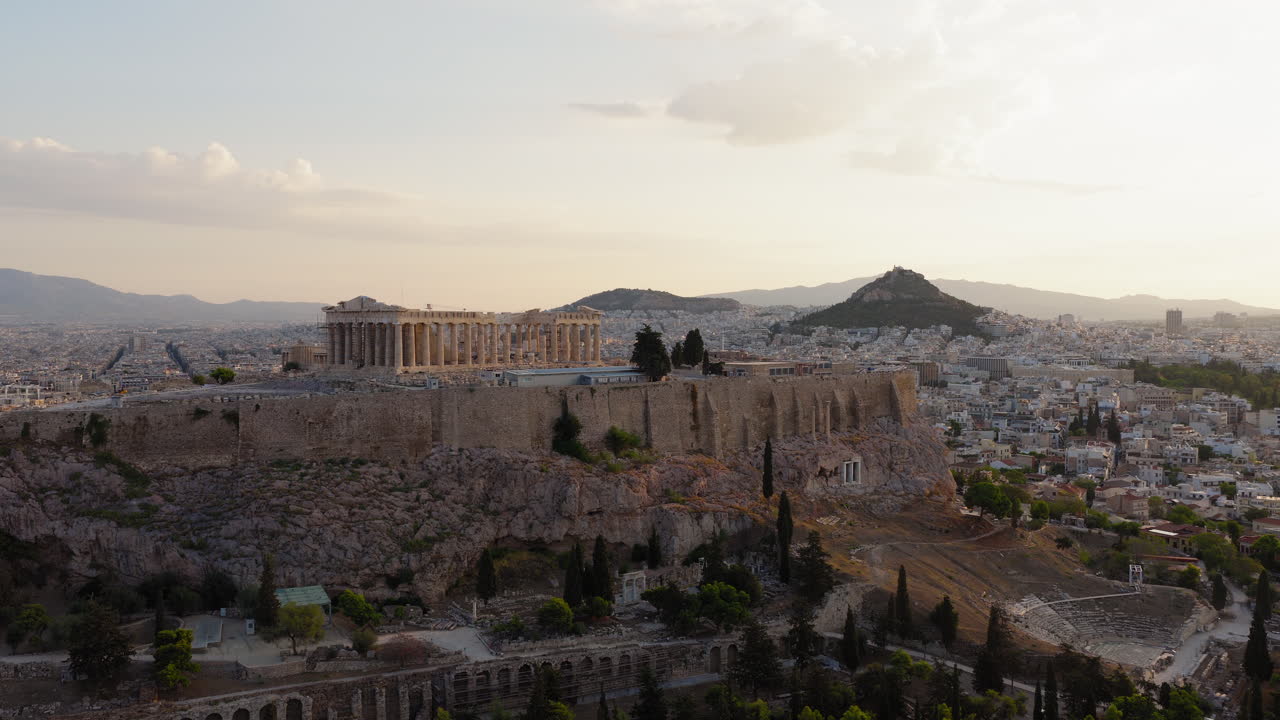 Drone shot of Acropolis of Athens from 5th century BC, Parthenon, Propylaea at sunrise, Panoramic view