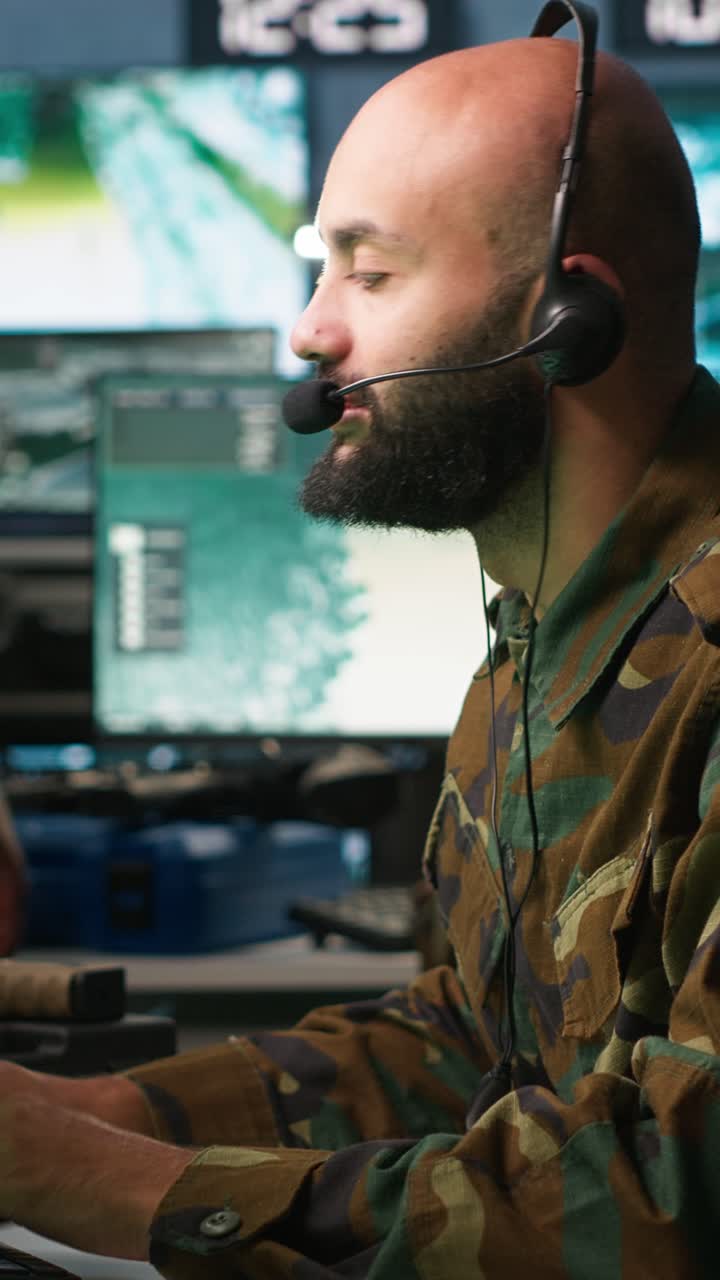 Vertical video Soldier solving tasks in military HQ base, gathering information on enemy troops