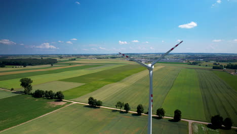 drone shot - moving away from a wind turbine