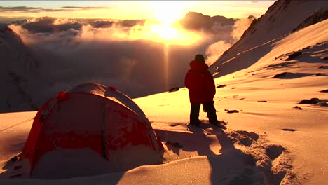 climber standing outside hit tent