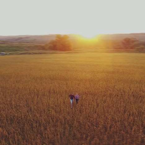 couple running away on the meadow