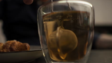 Tea-infuser-brewing-a-hot-cup-of-brown-Tea---Close-up