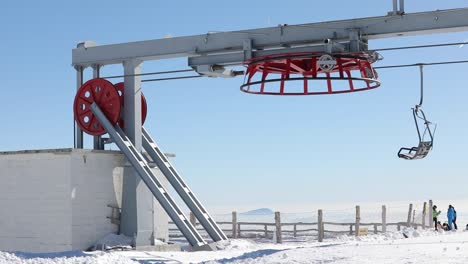 cable car ski lift atop of a mountain mechanism with chair rotating for return