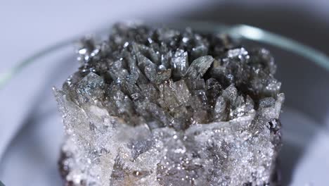 close-up of a crystal cluster on a petri dish