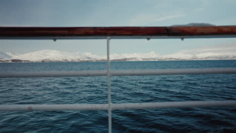 Static-Side-shot-of-Ship-Rails-Sailing-along-the-Snowy-Arctic-Fjords