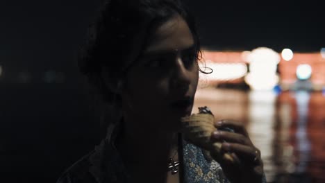 indian girl with silver jewelry eats ice cream at night