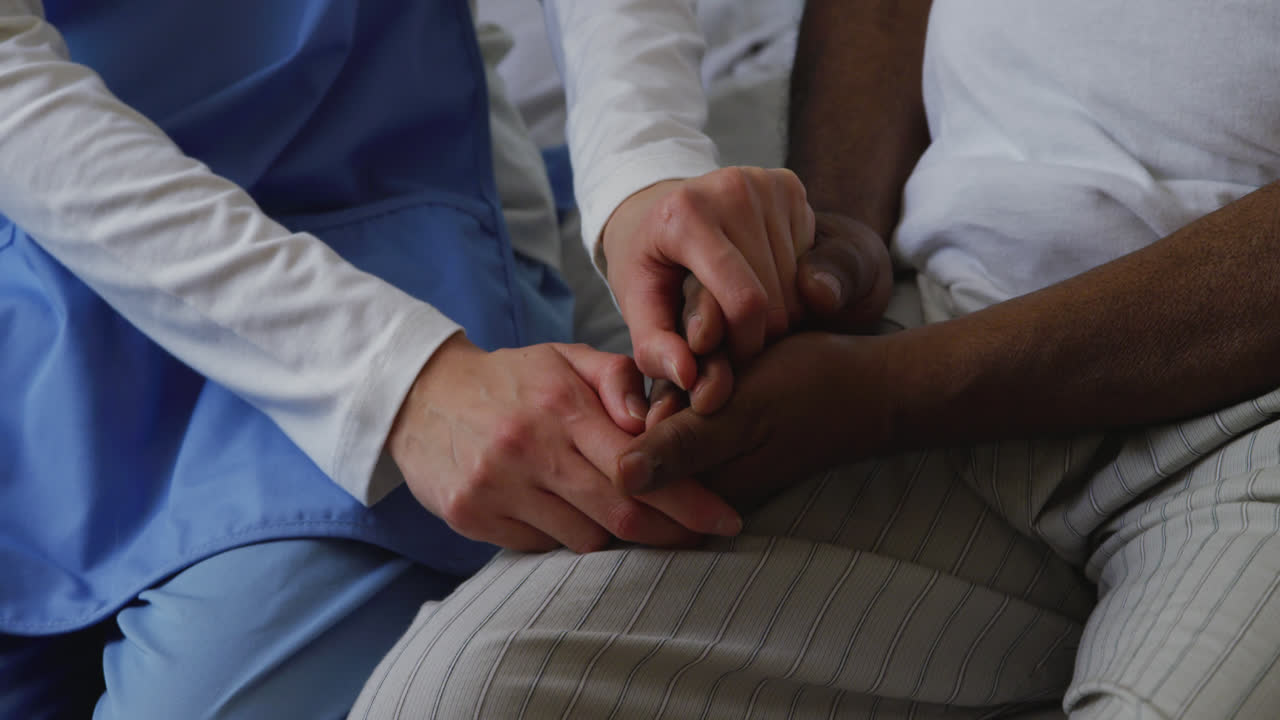 Nurse helping a senior man in retirement house