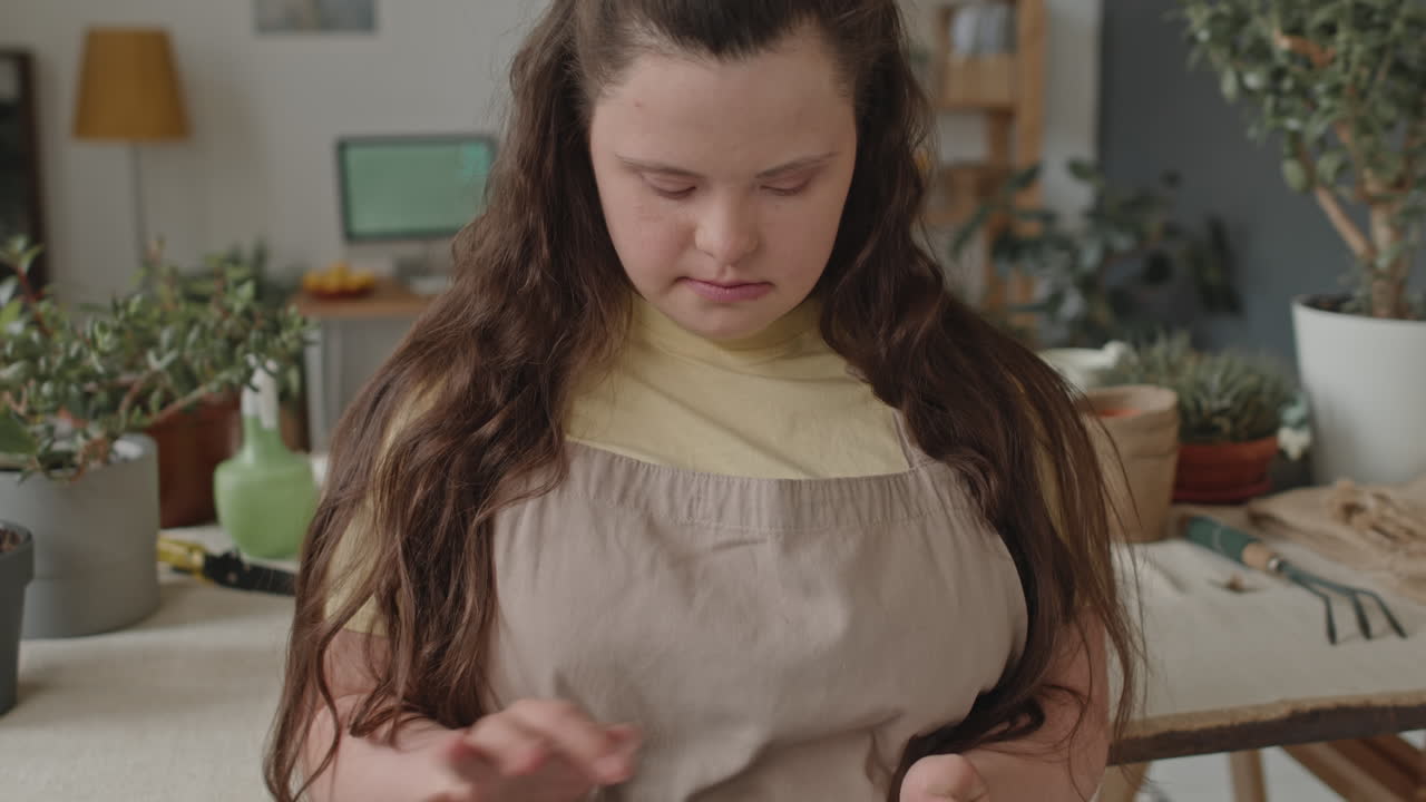 Woman with Down Syndrome tending to plants