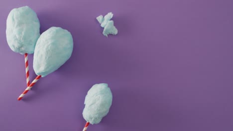 video of marshmallows on sticks lying on purple surface