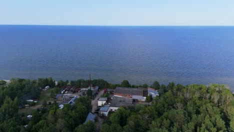 aerial drone footage of plienciems white dune in latvia on a sunny summer day. scenic baltic sea bay views, peaceful nature, and coastal landscape captured in cinematic quality