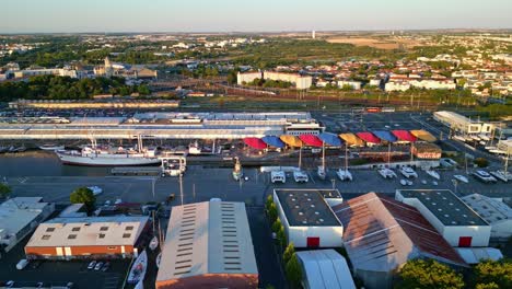 la rochelle port at golden hour, quai louis punier, maritime museum, boats, and cityscape, france. aerial drone sideways