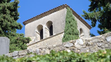 steeple of a provencal church under a sunny sky in slowmotion in summer