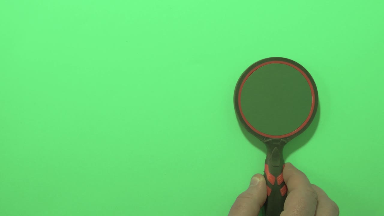 Hand with magnifying glass and green key and background