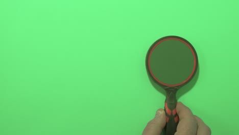 hand with magnifying glass and green key and background