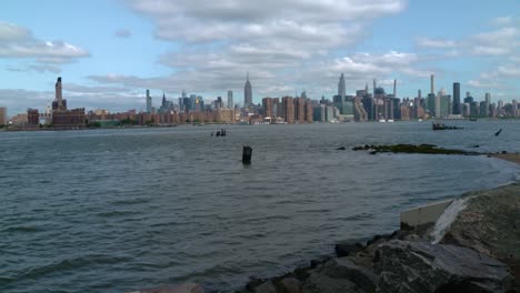 wide shot of the nyc skyline from the brooklyn side of the east river