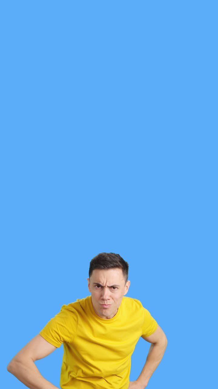 Man in Yellow Shirt with Serious Expression