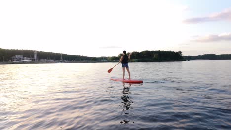 There-is-young-girl-paddle-boarding-in-the-big-lake