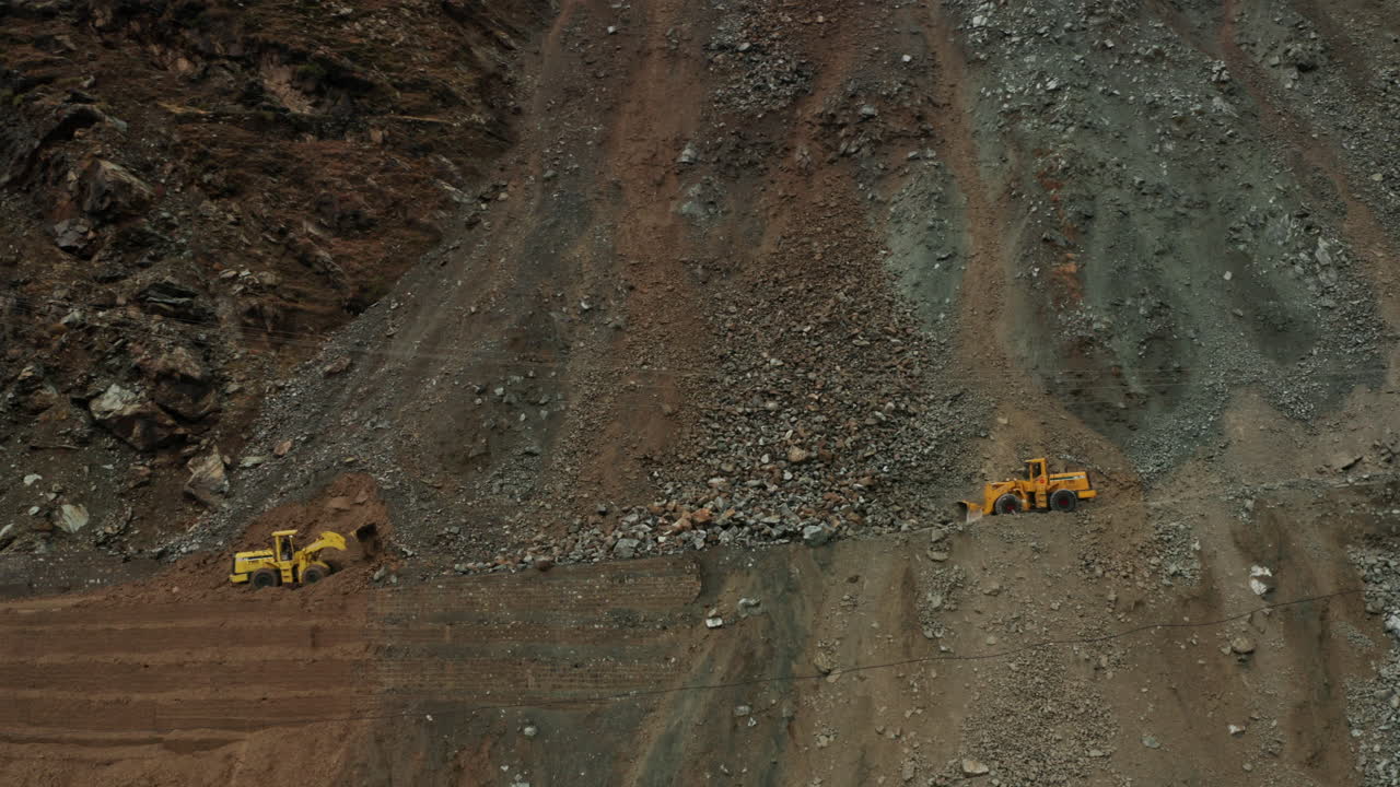 Close Up View Of Two Bulldozers Clearing Up The Landslide On Karakoram Highway In Dasu, Pakistan - aerial drone shot