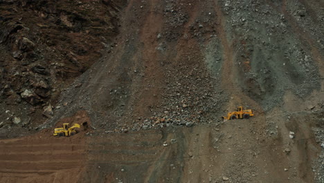Close-Up-View-Of-Two-Bulldozers-Clearing-Up-The-Landslide-On-Karakoram-Highway-In-Dasu,-Pakistan---aerial-drone-shot