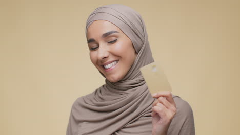 smiling woman holding credit card