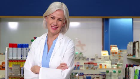 pharmacist standing at counter in pharmacy