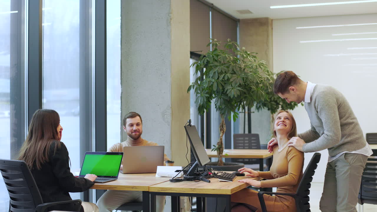 Coworkers talking in the office