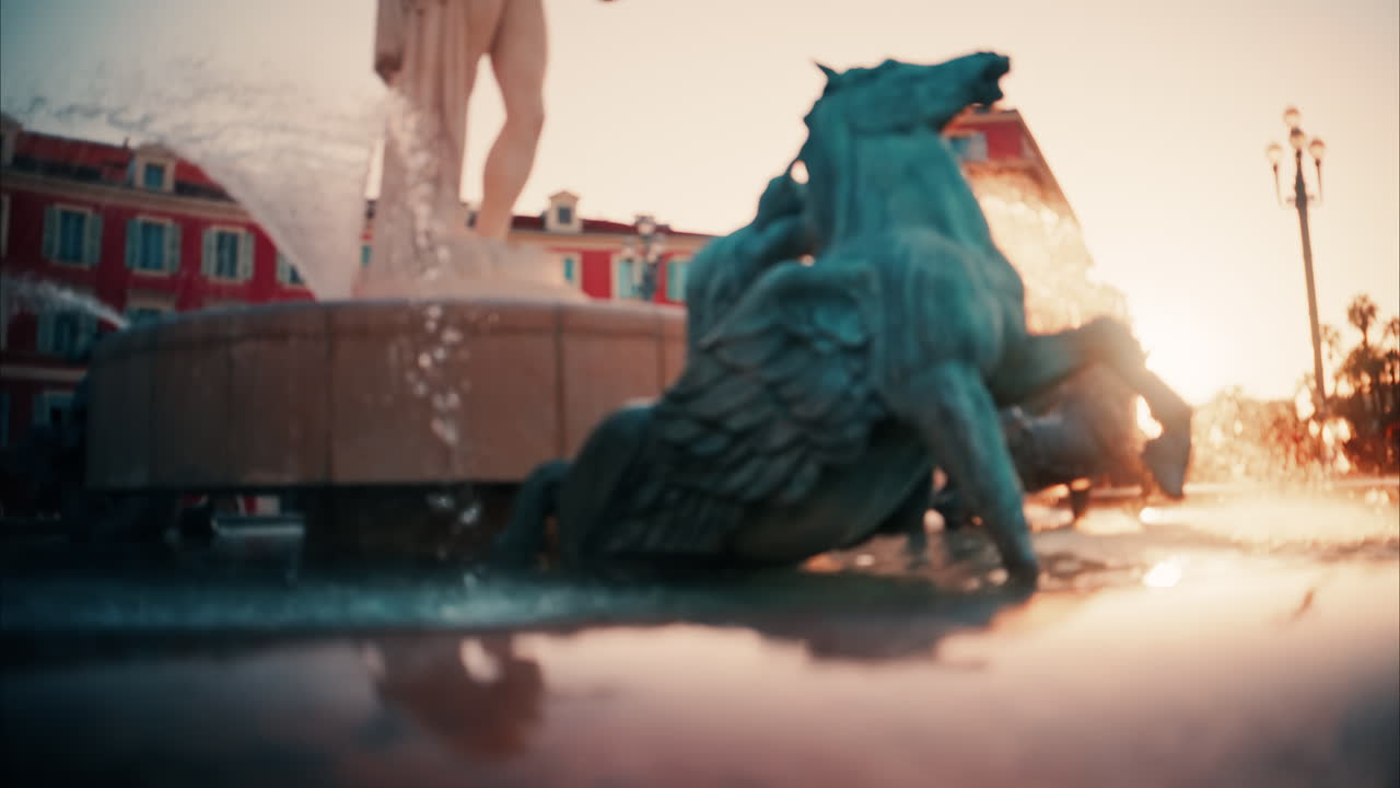 Nice, France - October 8, 2024: Blurry view of the Fontaine du Soleil in Place Massena at sunset