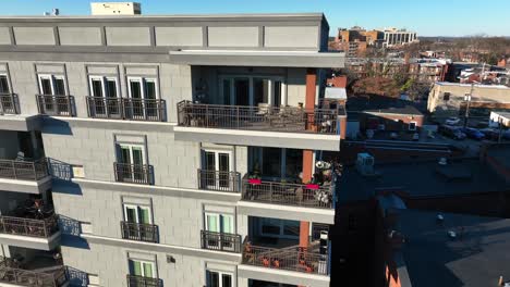 orbiting aerial view of exterior balconies on high end condo apartments in american city