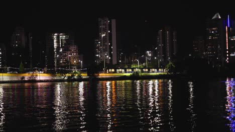 city lights reflecting on water at night