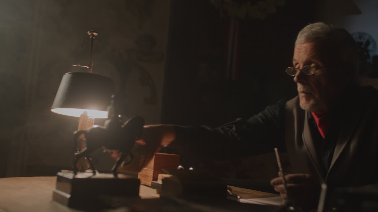 Older passionate man evaluates an old porcelain box