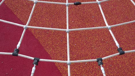 climbing net in the park. game equipment for children. tilt shot from bottom to top. the subject is in the middle.