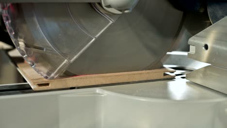 close-up of working on a machine with a circular saw
