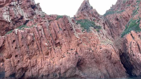 Incredible-primitive-Scandola-nature-reserve-landscape-in-summer-season-as-seen-from-moving-boat,-Corsica-island-in-France