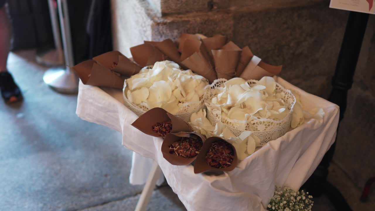 white rose petals and dried flower confetti arranged for wedding guests