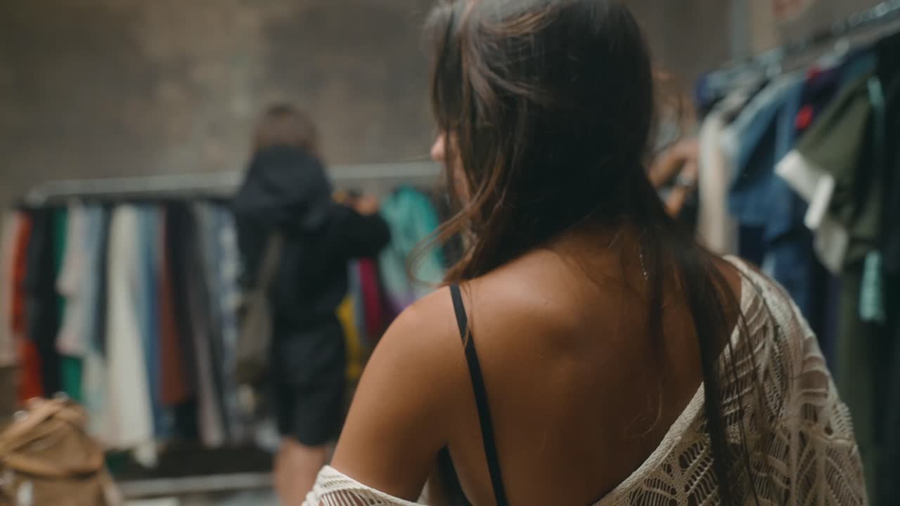Close-up of a Flower Arrangement in Front of Clothing Rack