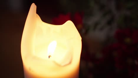 candle flickering on a table - close up
