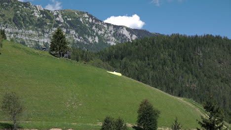 Flying-in-the-mountains,-paraglider-in-Alpine-landscape,-freedom-and-adventure-concept,-adrenaline-sport,-Logar-valley-in-Slovenia