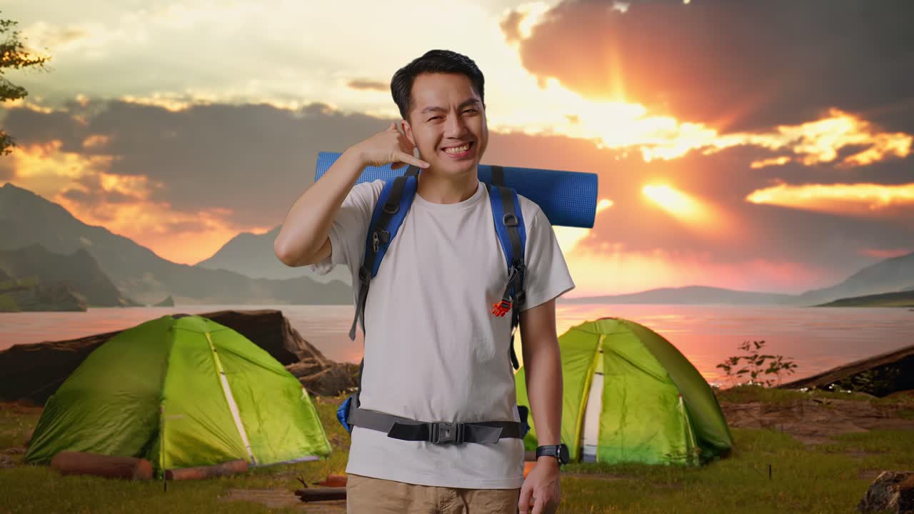 Smiling Man Camping and Making a Phone Call Gesture