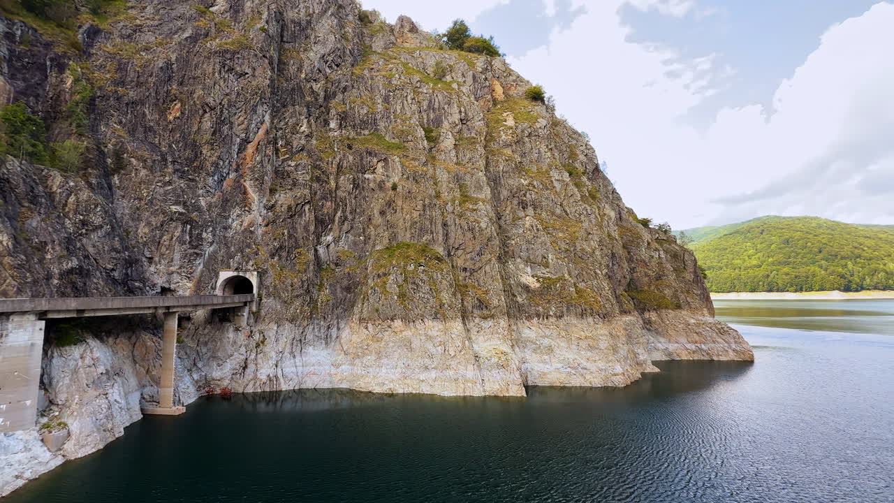 Tunnel and bridge at Vidraru Dam, Romania. Concrete bridge and tunnel built into the rocky cliffs at Vidraru Dam, Romania