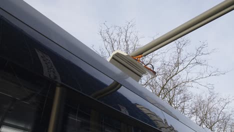 electric bus continues to ride after recharging the battery at the renewable energy station - close up