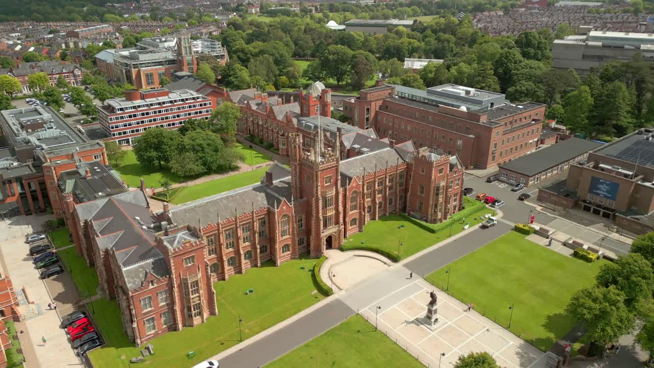 Side-on, ascending aerial video of Queen's University Belfast, in Northern Ireland, UK on a bright and sunny day. Produced at 4K resolution, 60FPS and with Rec709 color.