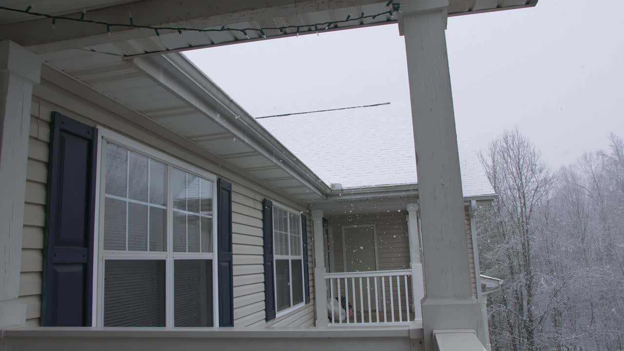 snow falling on apartment rooftop balcony porch woodstock georgia slow motion