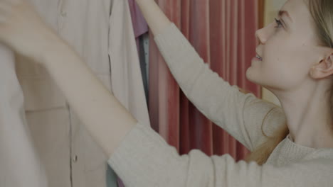 woman trying on clothes in a wardrobe