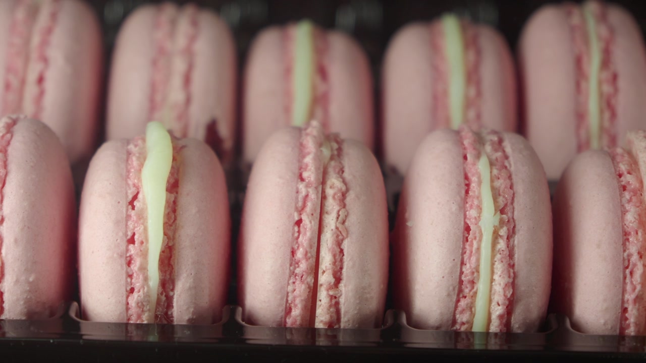 Close-up of Pink Macarons with Cream Filling in a Row
