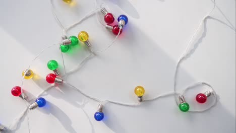 a bird's-eye view perspective of christmas led lights in blue, red, yellow, and green displayed on a white surface