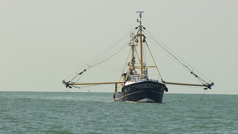 fishing boat trawling nets at sea on a calm day