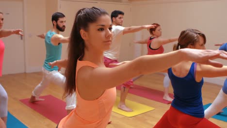 instructor assisting a group of people in exercise