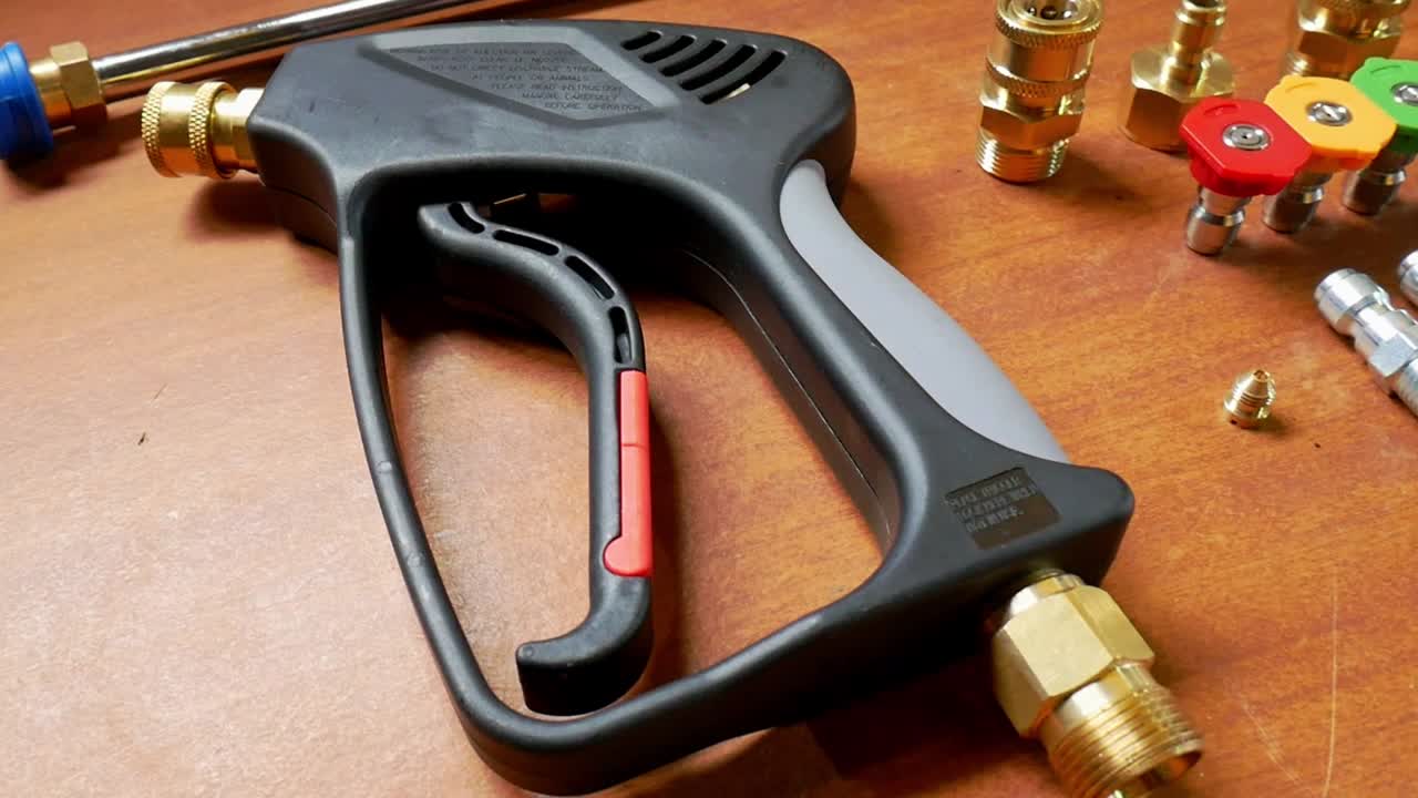 Top to bottom panning shot of pressure washer trigger gun with quick release accessories