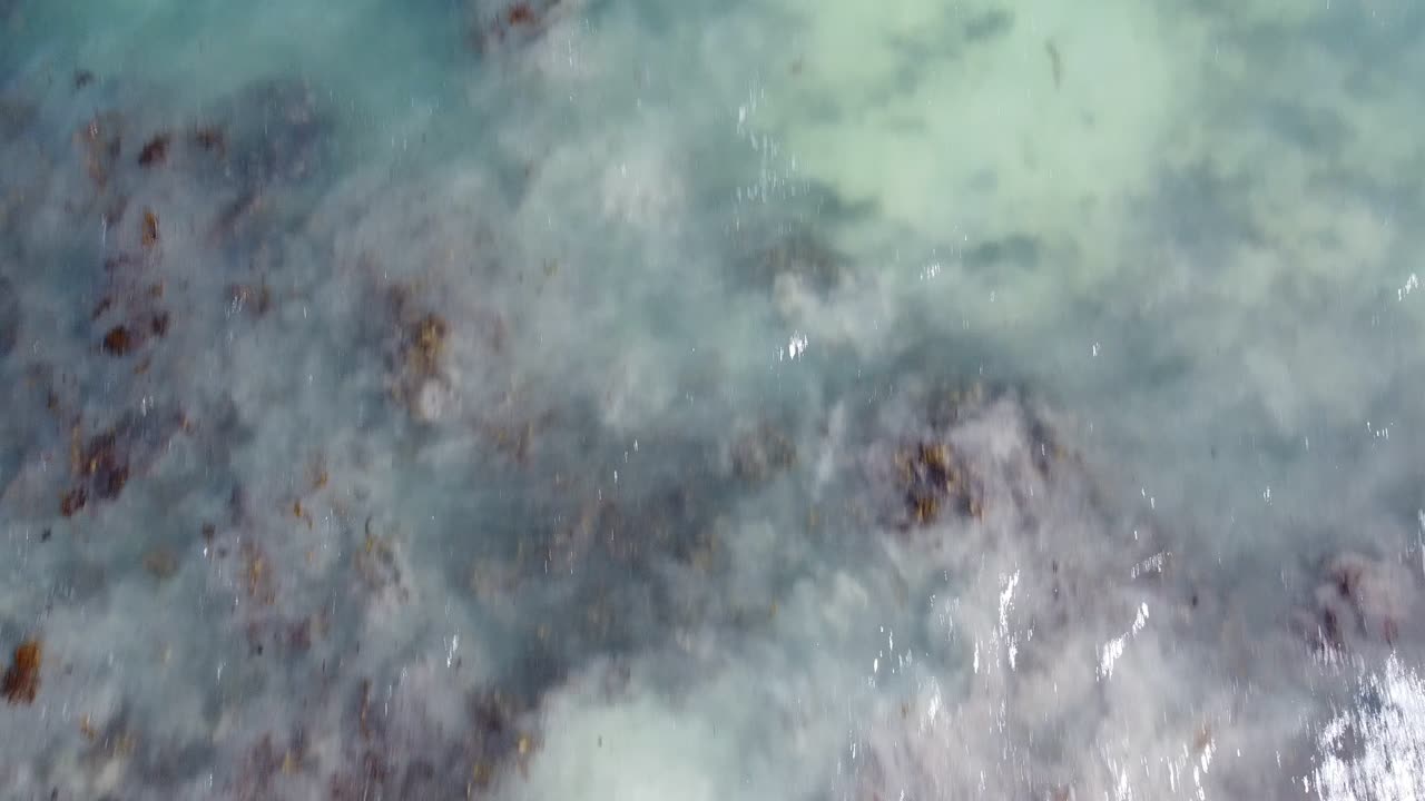 Drifting sand under surface of incoming tide