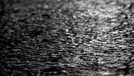 loseup shot of heavy rain on road/rain road in london street at night, loop background